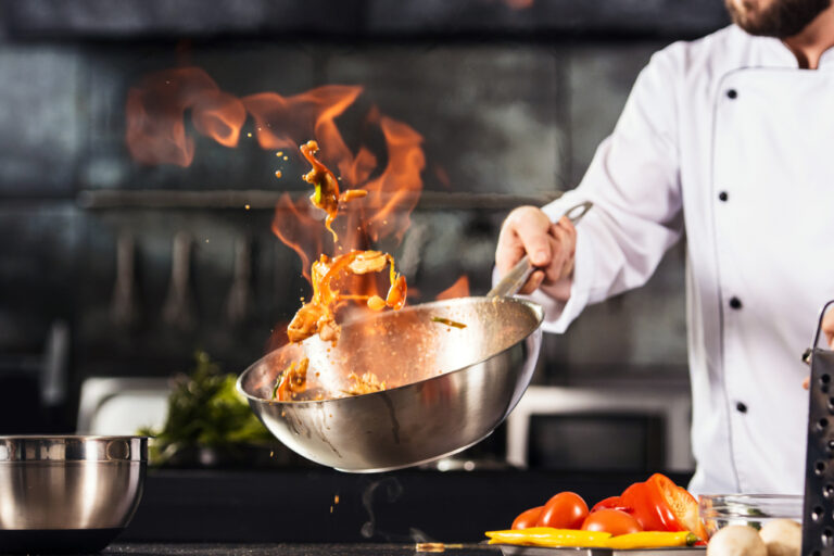 Chef cooking in the cooking zone of a restaurant kitchen