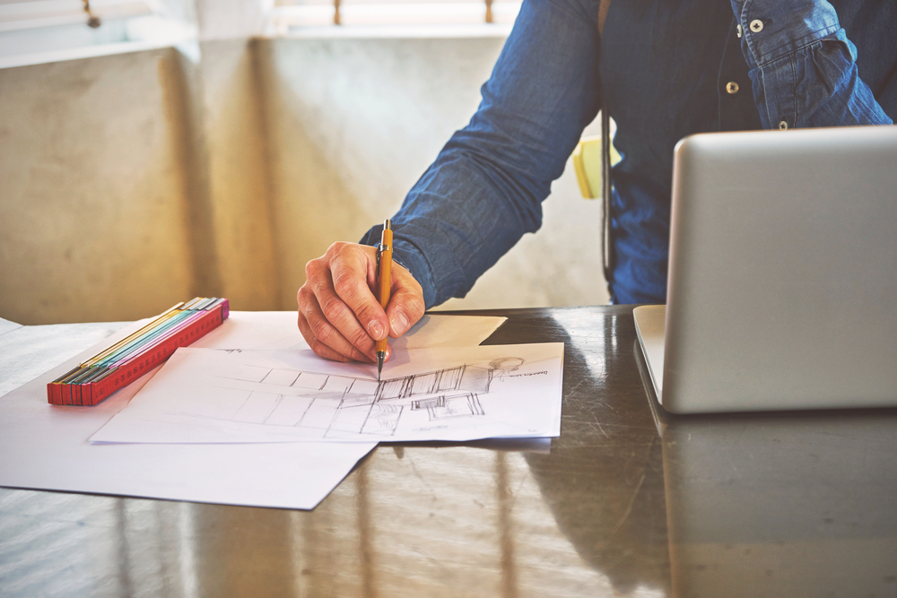 Architect or commercial kitchen designer sketching a kitchen in his office